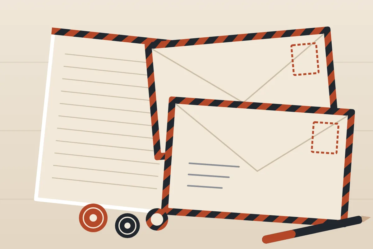 Illustration from above of a sheet of lined writing paper and two envelopes with striped airmail borders, with three round stickers and a pen on a pale desk